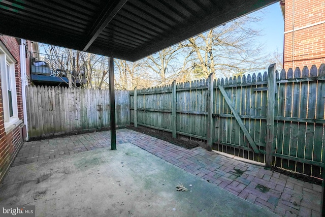 view of patio with a fenced backyard and a gate