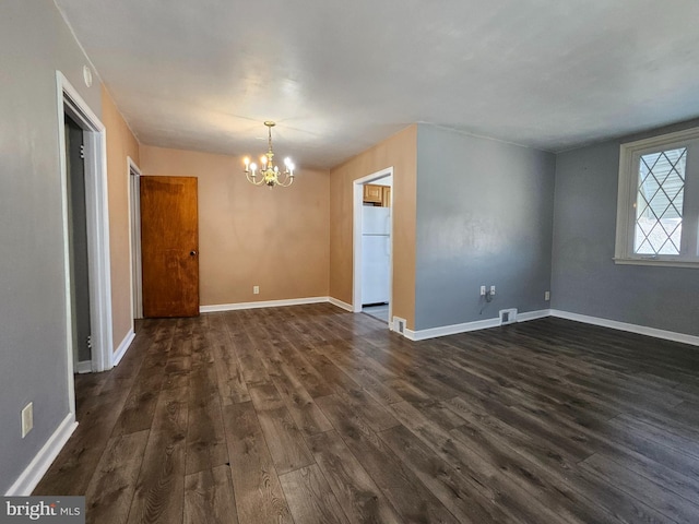 interior space with a notable chandelier, visible vents, baseboards, and dark wood-style flooring