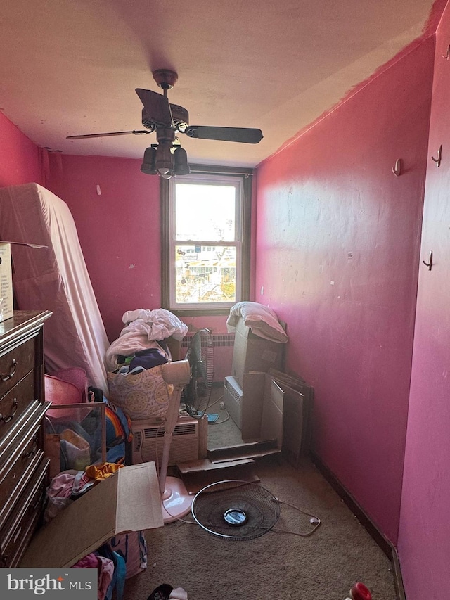 interior space featuring carpet flooring, a ceiling fan, and baseboards