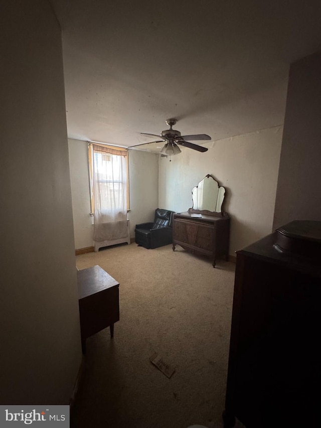 bedroom featuring a ceiling fan and light colored carpet