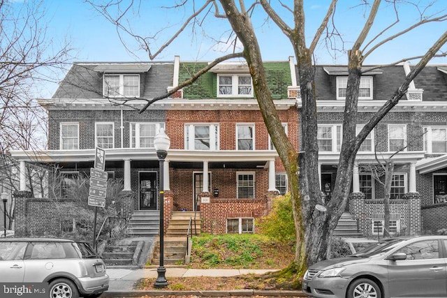 townhome / multi-family property featuring brick siding