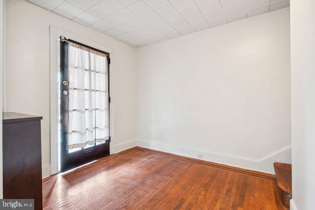 interior space with wood finished floors and baseboards