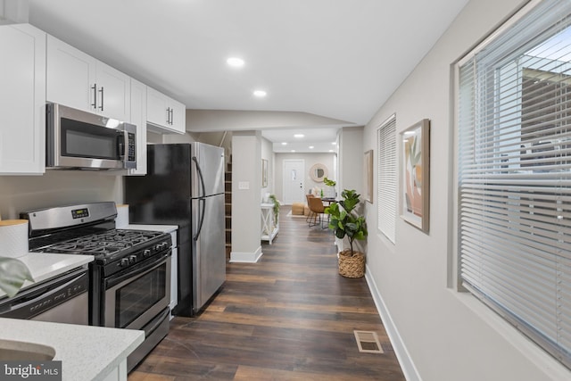 kitchen with visible vents, dark wood-style floors, appliances with stainless steel finishes, light countertops, and white cabinetry