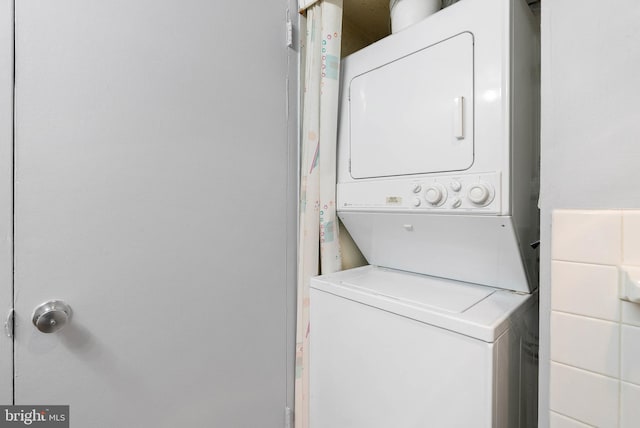 laundry room with laundry area and stacked washer / drying machine