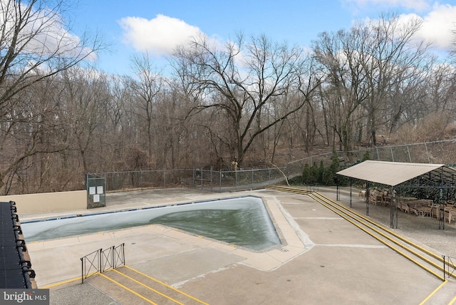 pool featuring fence and a gazebo