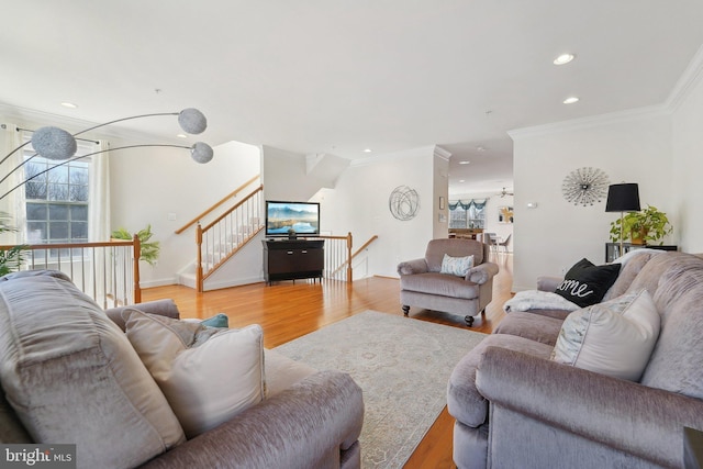 living area featuring ornamental molding, wood finished floors, and recessed lighting