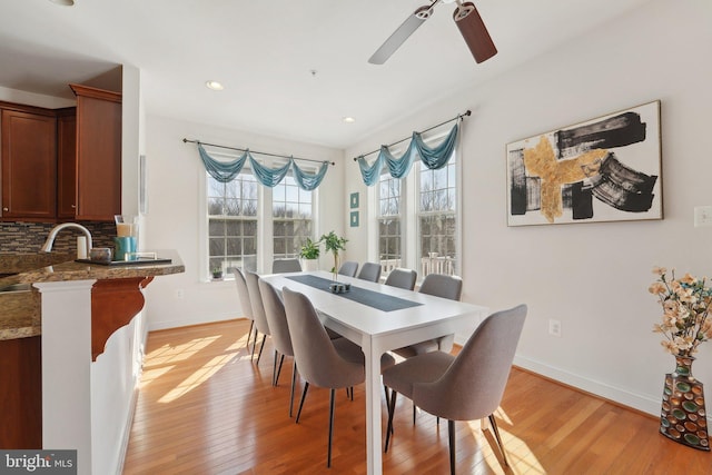 dining room featuring light wood-style flooring, baseboards, ceiling fan, and recessed lighting