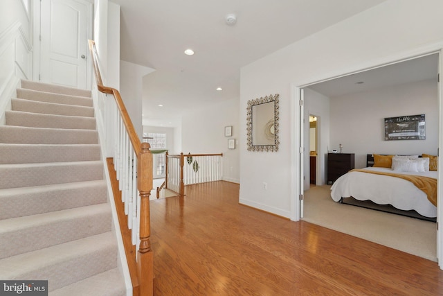 interior space featuring baseboards, wood finished floors, and recessed lighting