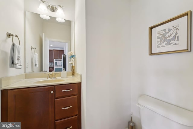 bathroom featuring toilet and vanity