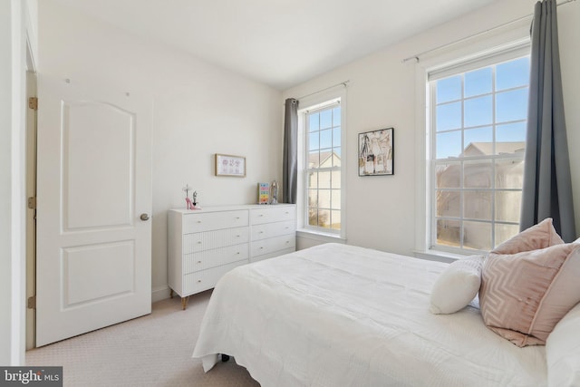 bedroom featuring light colored carpet