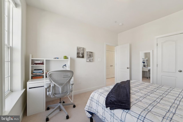 carpeted bedroom featuring baseboards