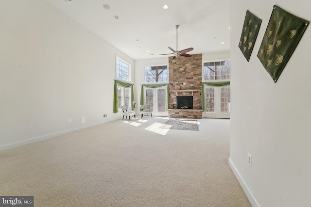 unfurnished living room featuring a large fireplace, baseboards, ceiling fan, carpet floors, and recessed lighting