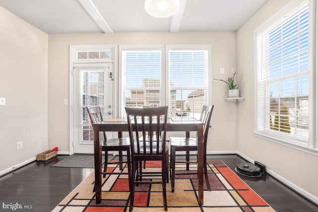 dining space featuring beam ceiling, baseboards, and dark wood-style flooring