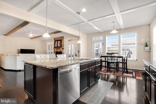 kitchen featuring a center island with sink, dark wood finished floors, open floor plan, hanging light fixtures, and stainless steel dishwasher