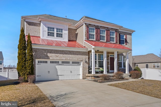 view of front of house featuring brick siding, fence, and an attached garage