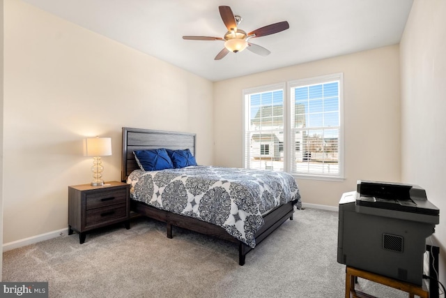 bedroom with light carpet, ceiling fan, and baseboards