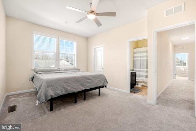 bedroom featuring baseboards, multiple windows, and visible vents