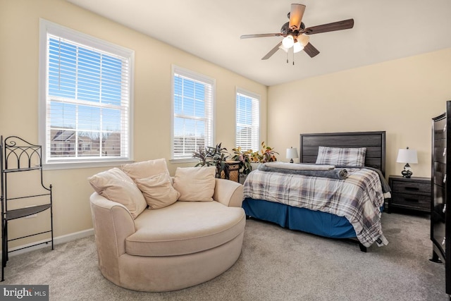 bedroom featuring baseboards and light colored carpet