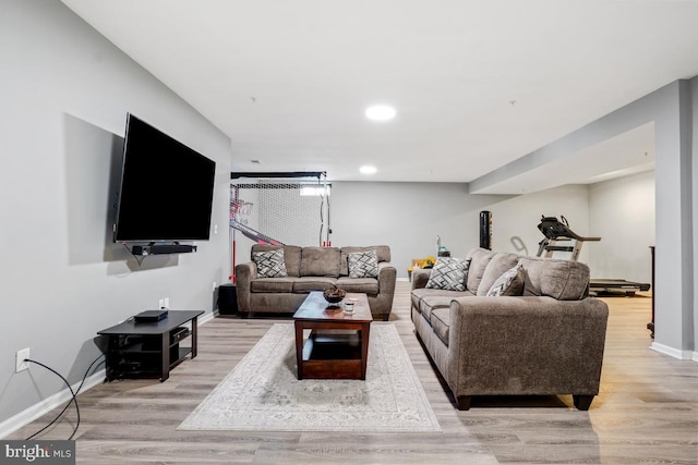 living room featuring recessed lighting, light wood-style flooring, and baseboards