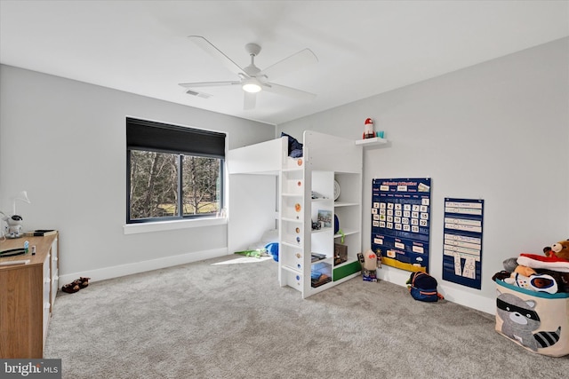 interior space with visible vents, carpet flooring, baseboards, and a ceiling fan