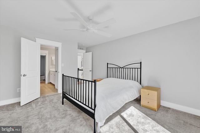 carpeted bedroom with visible vents, baseboards, and ceiling fan