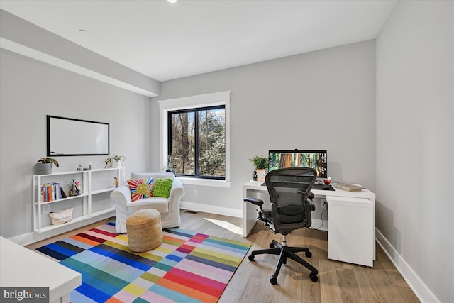 home office featuring baseboards and wood finished floors