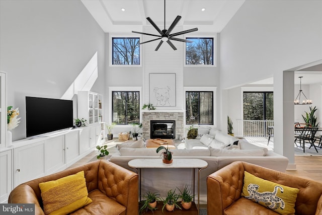 living room with a stone fireplace and a healthy amount of sunlight