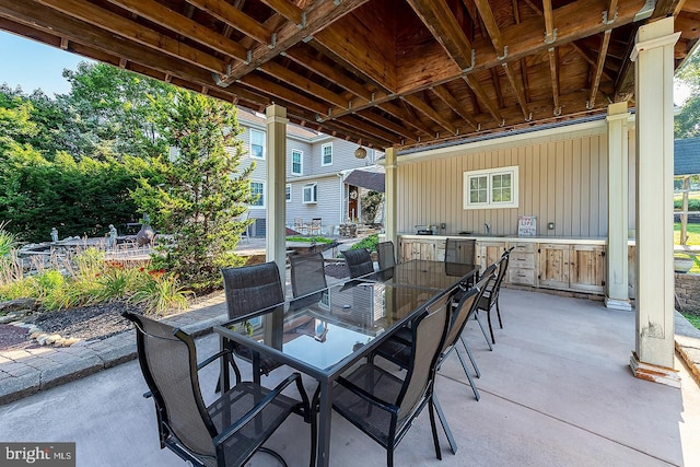 view of patio / terrace with a sink and outdoor dining space