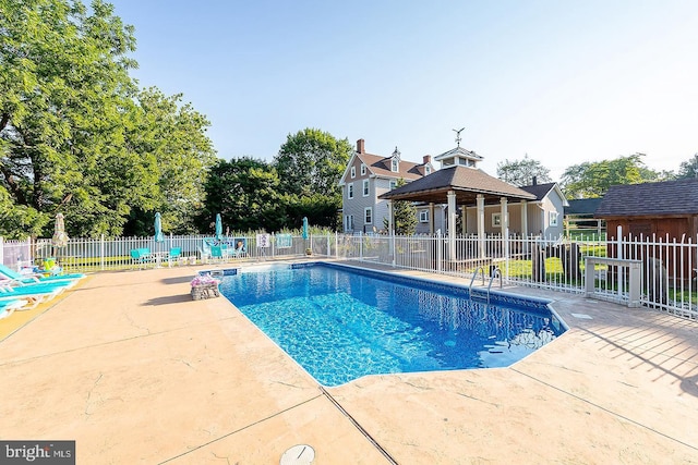 view of pool with fence, a fenced in pool, and a patio