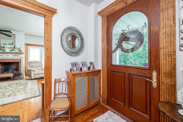 entryway with hardwood / wood-style flooring and a fireplace