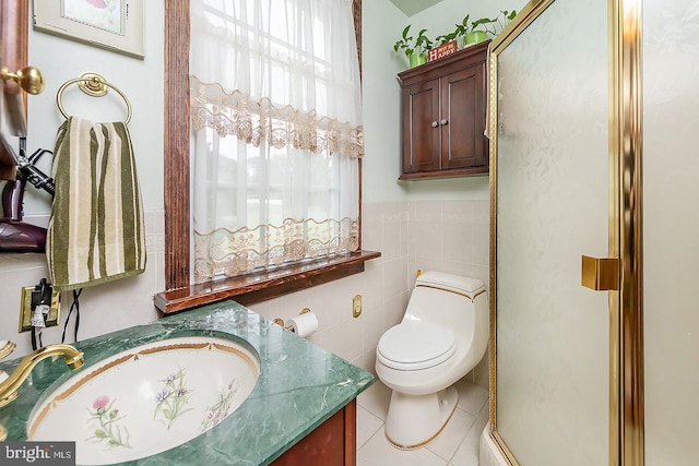 bathroom featuring toilet, tile patterned flooring, tile walls, and vanity