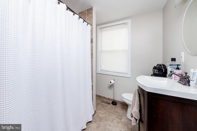 bathroom with toilet, baseboards, visible vents, and vanity