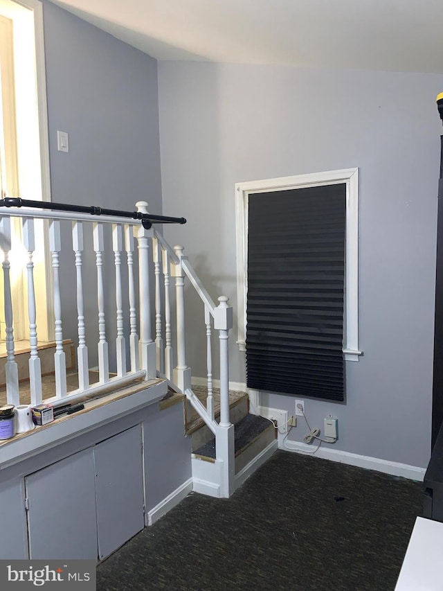 staircase with carpet floors and baseboards