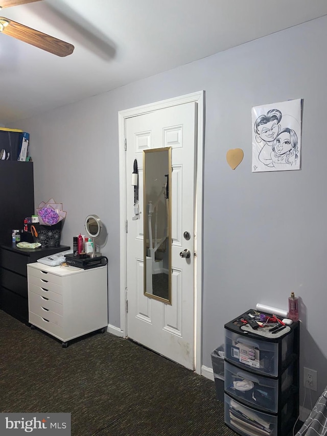 bedroom with dark colored carpet, ceiling fan, and baseboards