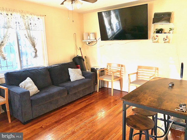 living room with ceiling fan and wood finished floors