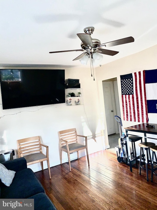 living room featuring a ceiling fan and wood finished floors