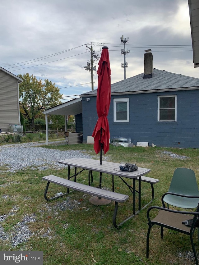 view of community with a yard and fence