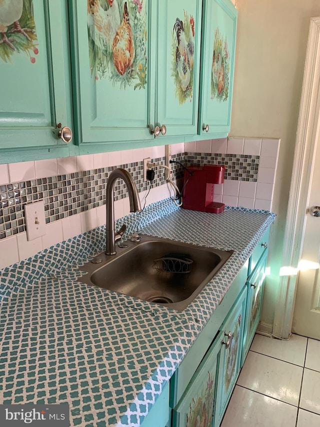 room details featuring light countertops, a sink, and backsplash