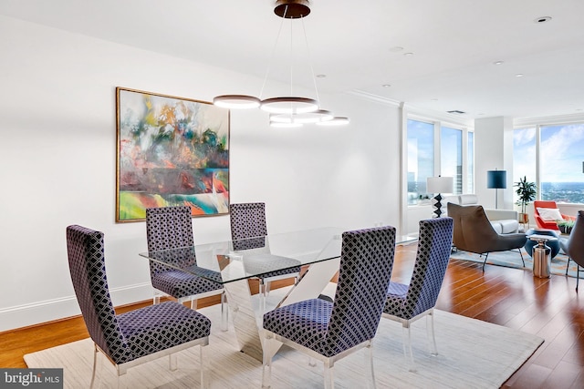 dining area with wood finished floors and baseboards