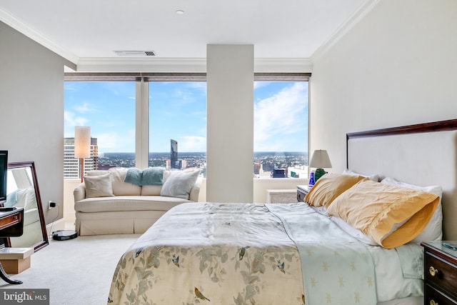 bedroom with crown molding, visible vents, a city view, and light colored carpet