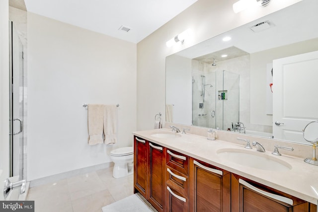 bathroom featuring tile patterned flooring, a sink, toilet, and a shower stall