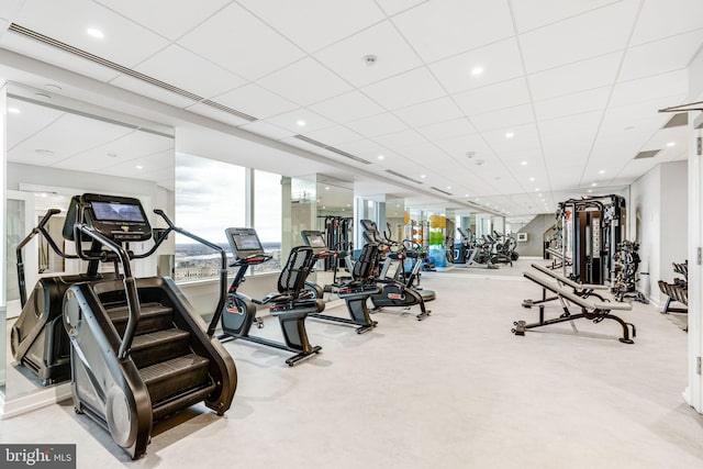 workout area with light carpet, a paneled ceiling, and recessed lighting