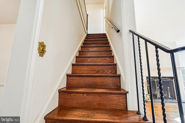 stairway featuring wood finished floors