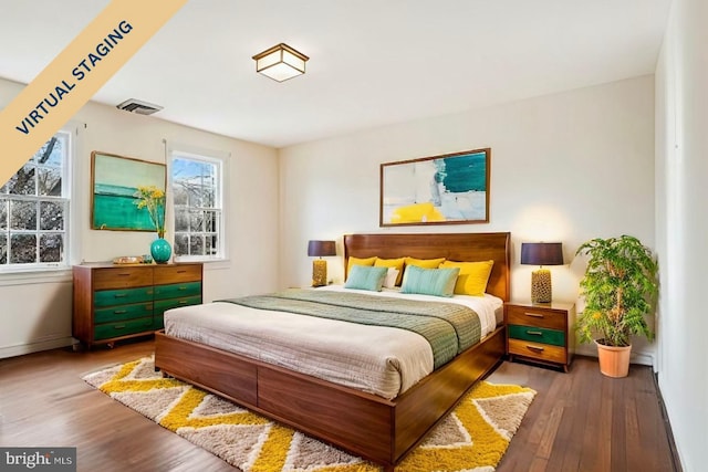 bedroom featuring baseboards and wood finished floors