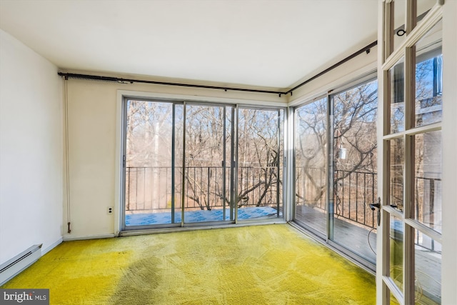 interior space featuring a baseboard heating unit and a wealth of natural light