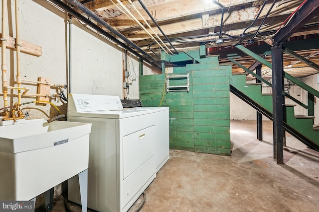 laundry area featuring laundry area, separate washer and dryer, and a sink