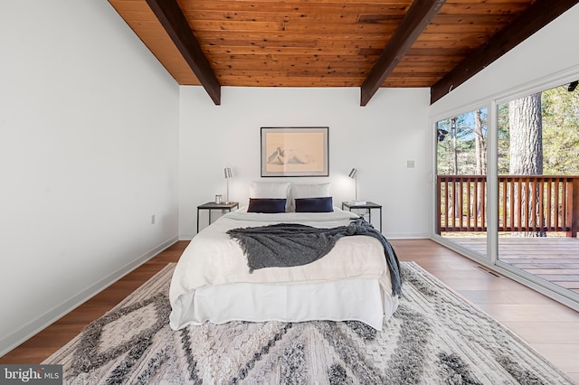 bedroom with access to exterior, wood finished floors, baseboards, and wooden ceiling