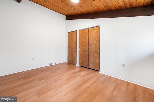 unfurnished bedroom with wood ceiling, wood finished floors, multiple closets, and baseboards