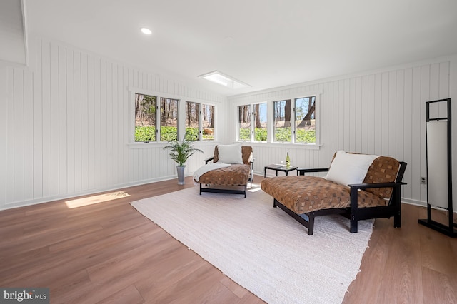 sitting room featuring recessed lighting, wood finished floors, baseboards, and a wealth of natural light