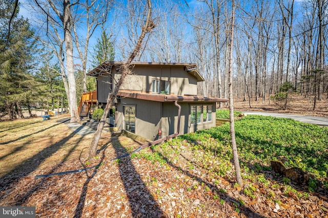 view of side of property featuring stairway